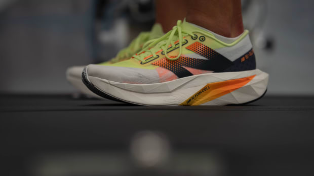 Side view of a white and black New Balance running shoe.